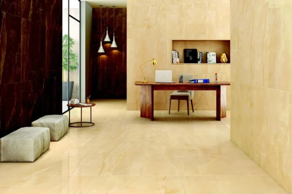 Modern office space with cream marble walls, wooden desk, pendant lights, built-in shelving, and beige seating in a minimalist interior.