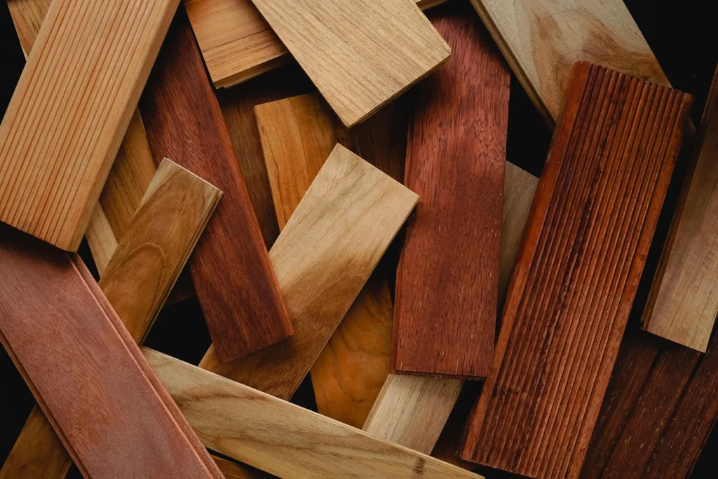 Collection of wood flooring samples in various stains and finishes arranged on dark background.